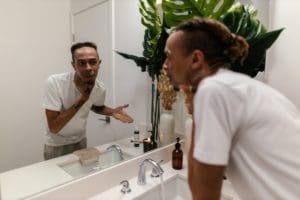 alcohol allergies, man, mirror, alcohol, sick, bathroom