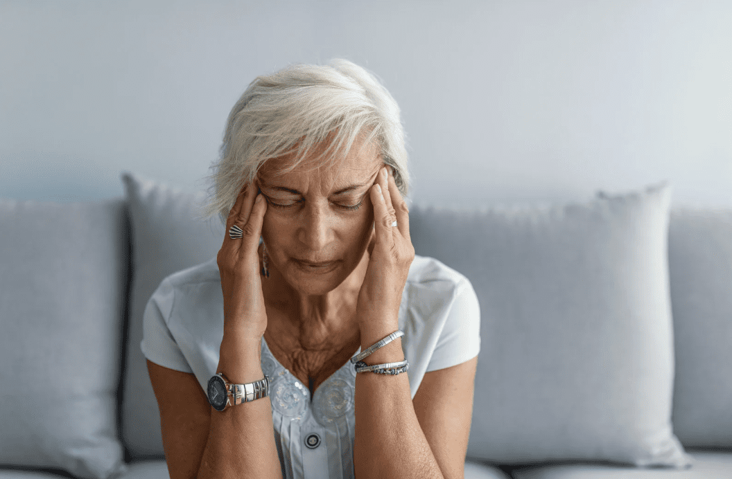 A woman holding her head.
